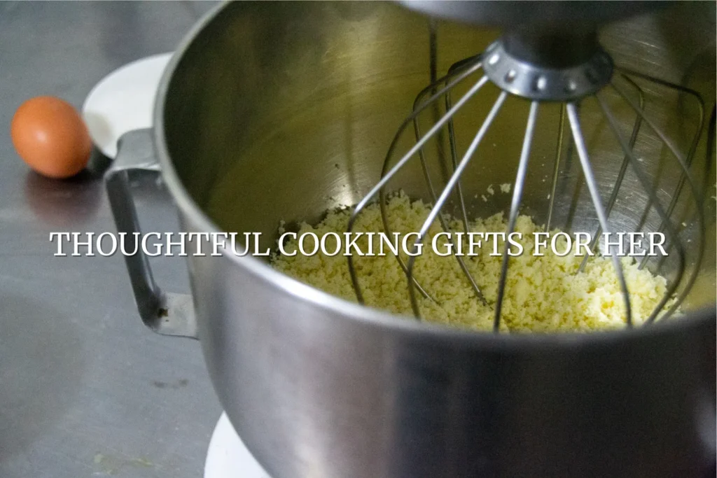 gifts for her cooking together in the kitchen stand mixer with wire wisk and an egg on the counter.