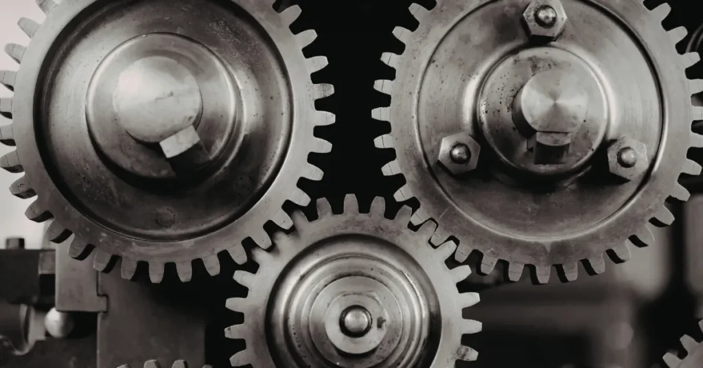 Black and white close-up of interlocking metal gears, symbolizing precision, calibration, and engineered accuracy