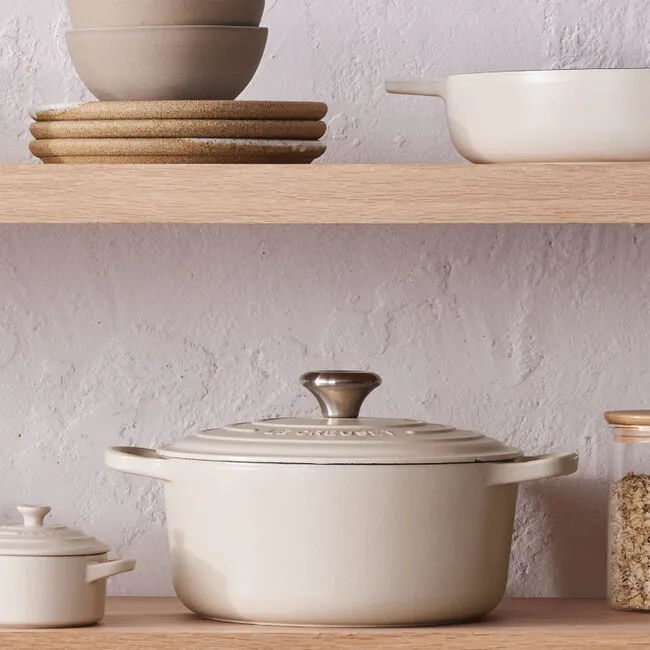 Le Creuset color story featuring a Brioche Dutch oven styled on a neutral kitchen shelf